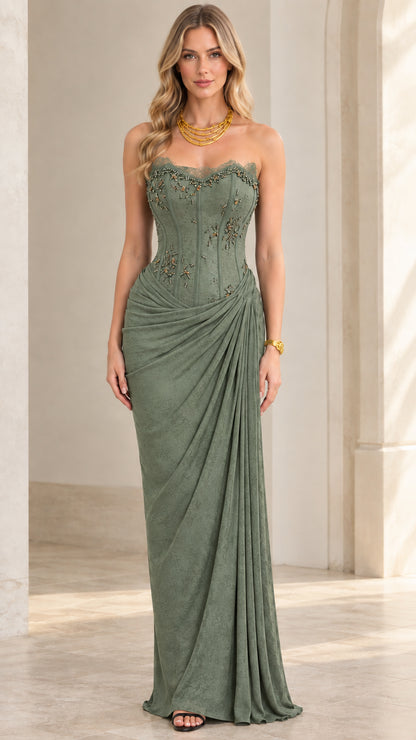 Model wearing sage green strapless corset draped maxi dress