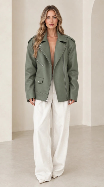 Front view of woman wearing oversized sage green faux leather biker jacket