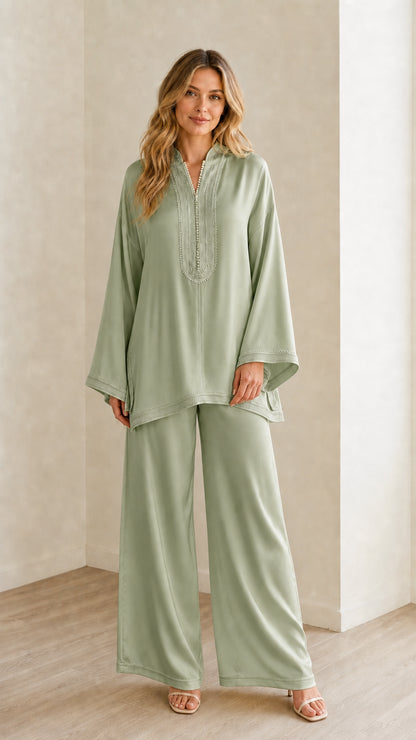 Full-length view of woman wearing the sage green embroidered tunic and wide-leg pants set