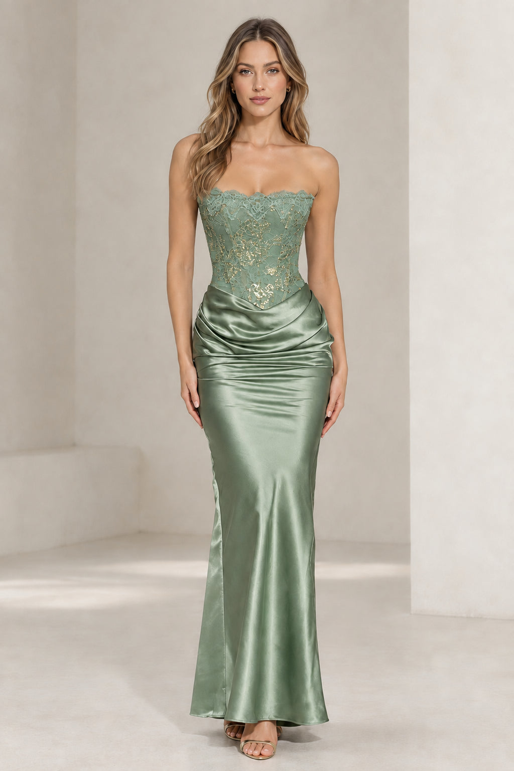 Front view of woman wearing sage green strapless lace corset satin evening dress
