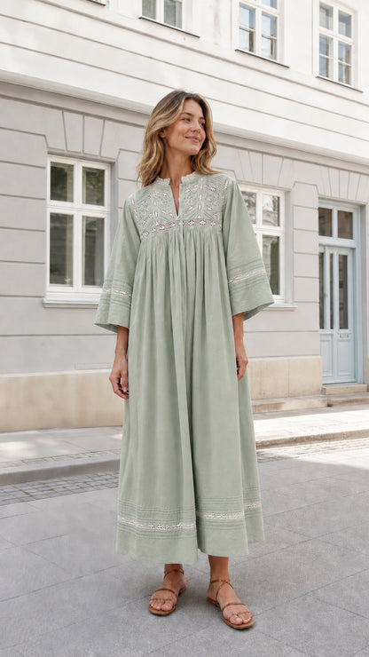 Woman wearing Sage Green flowy embroidered peasant maxi dress