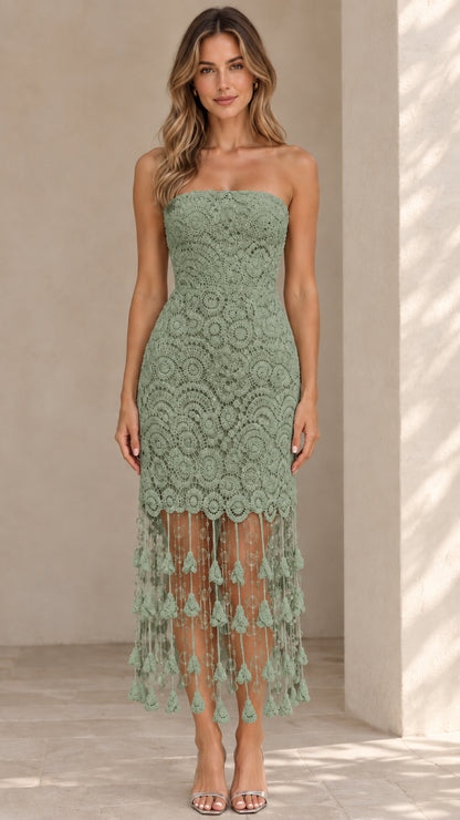 Front view of model wearing sage green strapless lace midi dress with tassel hem