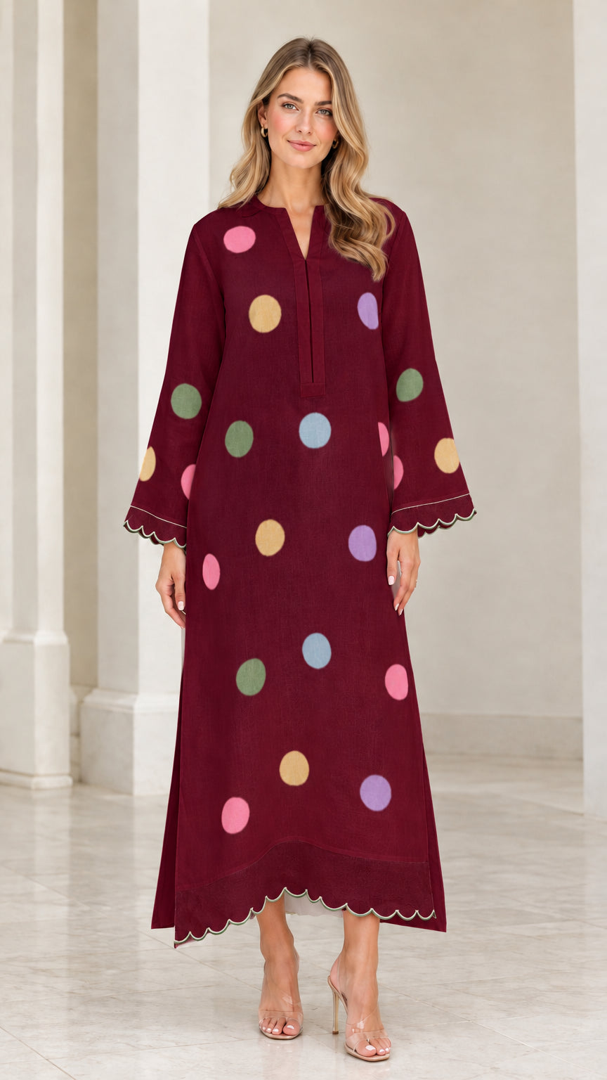 Woman wearing deep burgundy polka dot long sleeve maxi kaftan dress