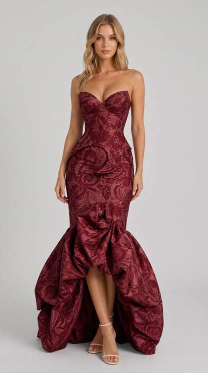 Model wearing rich burgundy brocade mermaid formal gown