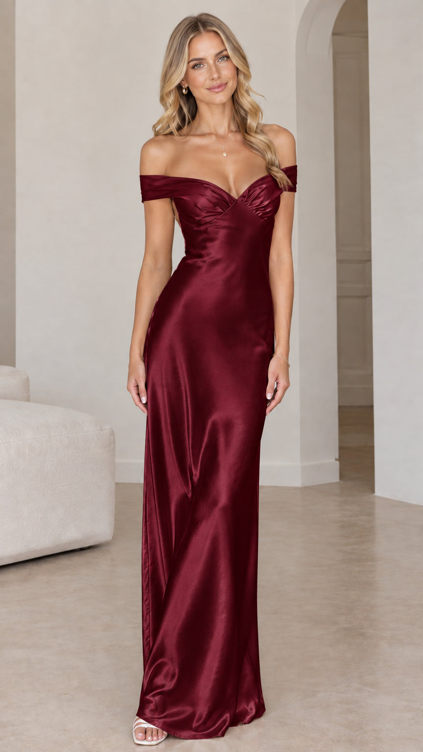 Front view of woman wearing burgundy off-the-shoulder satin maxi gown