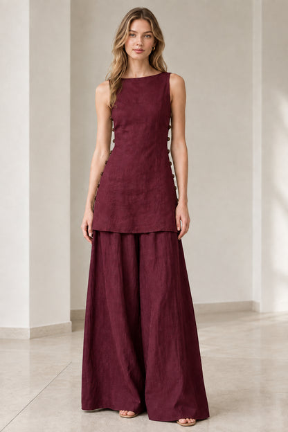 Model wearing rich burgundy wine sleeveless longline top and matching wide-leg pants