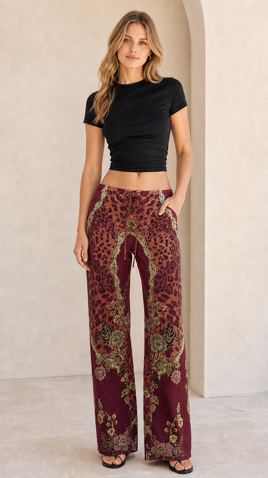 Front view of model wearing burgundy red leopard and baroque print wide leg pants