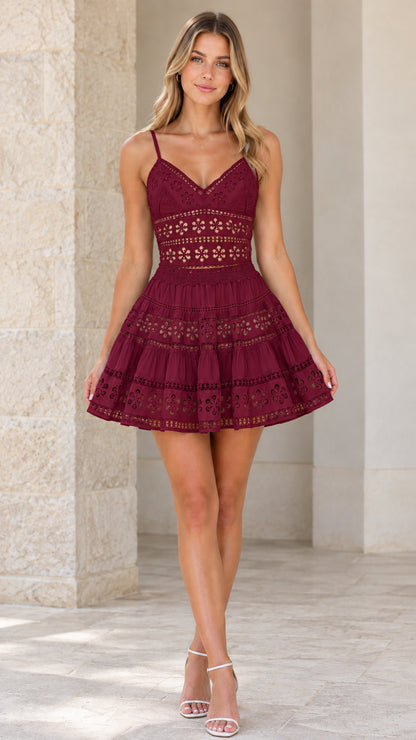 Model wearing Burgundy floral eyelet lace tiered mini dress