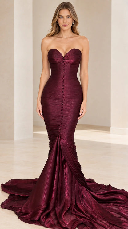 Model wearing deep burgundy strapless pleated mermaid evening dress