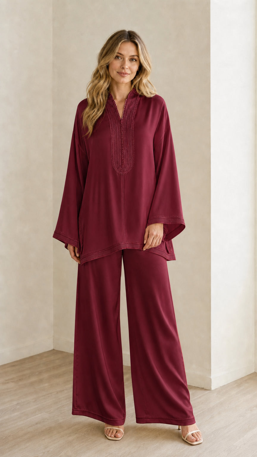 Full-length view of woman wearing the deep burgundy embroidered tunic and trouser outfit