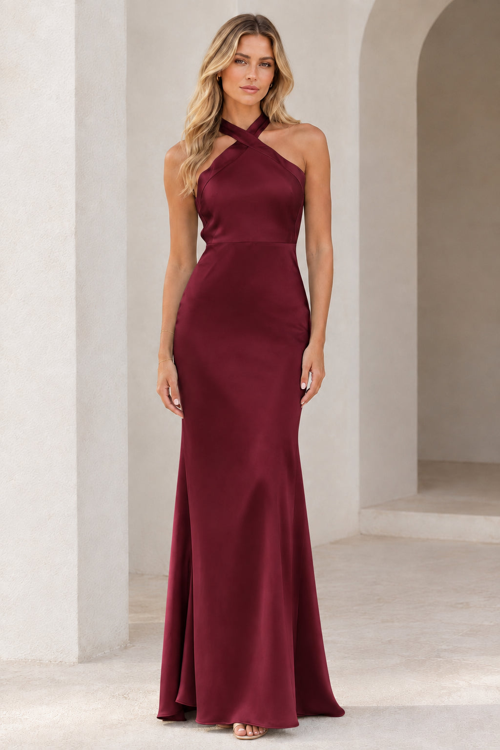 Full-length view of Burgundy cross halter satin evening gown