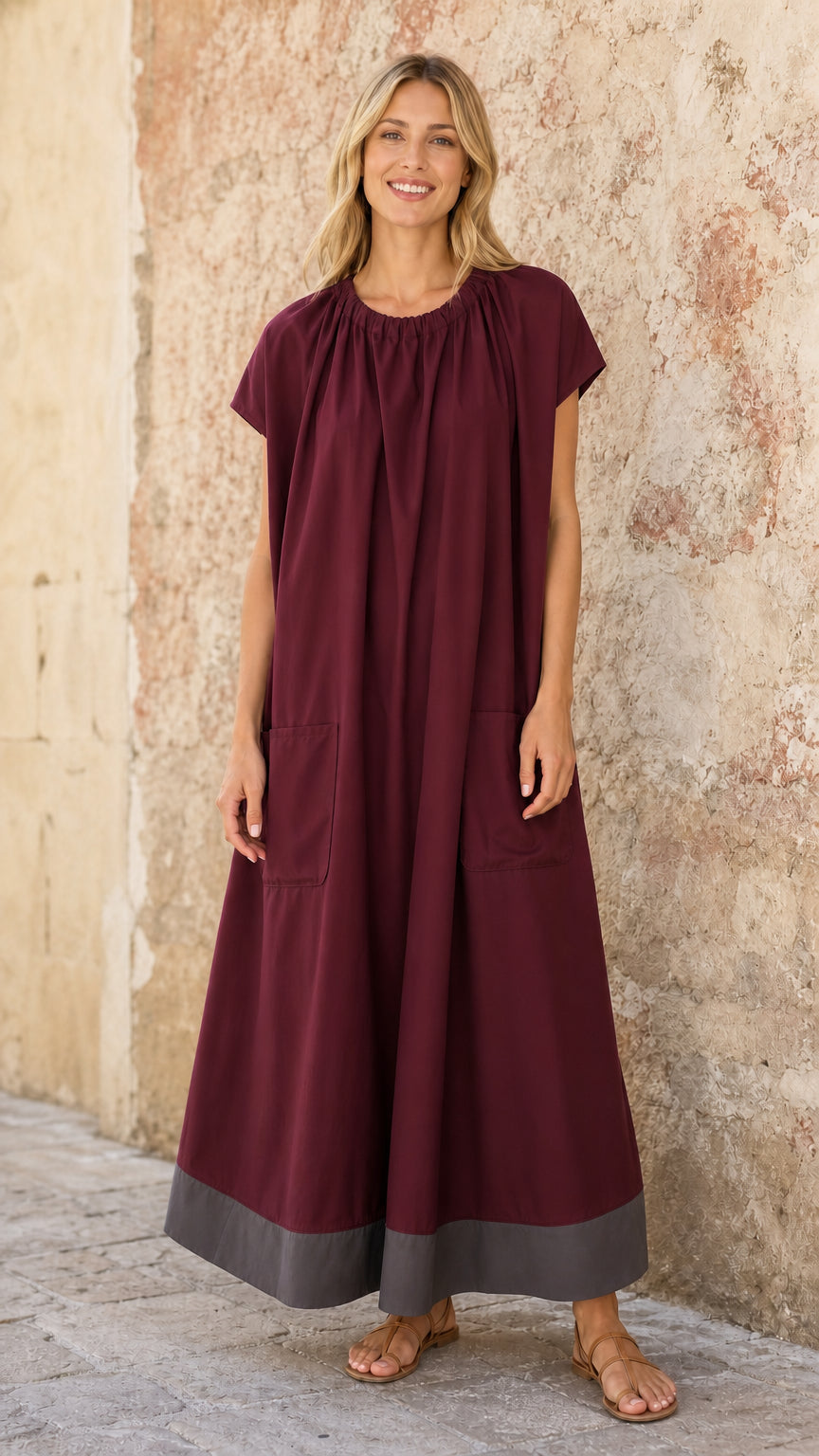 Model wearing Burgundy flowy A-line maxi dress with colorblock hem