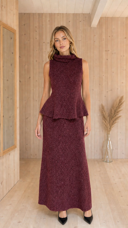 Front view of woman wearing Burgundy sleeveless peplum top and maxi skirt knit set