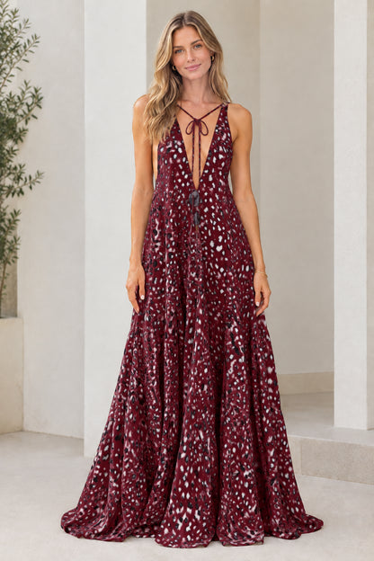 Model wearing burgundy wine dotted plunge neck tiered maxi dress