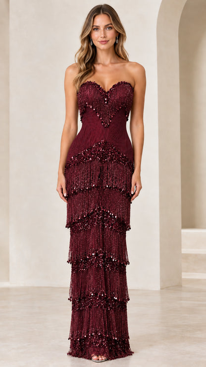 Front view of woman wearing burgundy wine strapless beaded fringe maxi dress