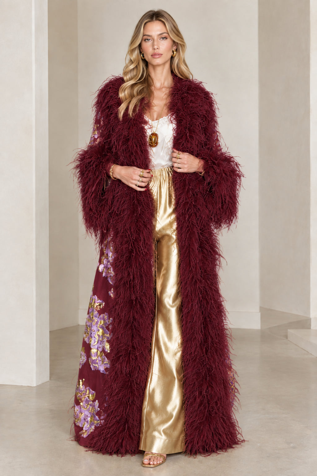 Full-length view of burgundy floral brocade maxi coat with deep red feather trim