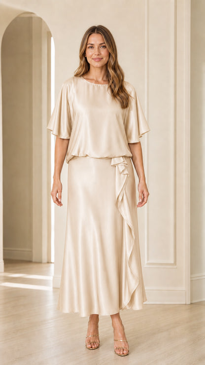 Front view of woman wearing champagne gold satin flutter sleeve evening dress