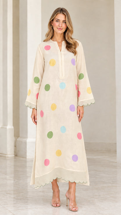 Woman wearing cream beige polka dot long sleeve maxi kaftan dress