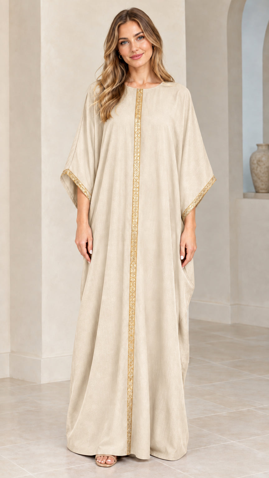Full front view of model wearing beige cream kaftan maxi dress with gold trim