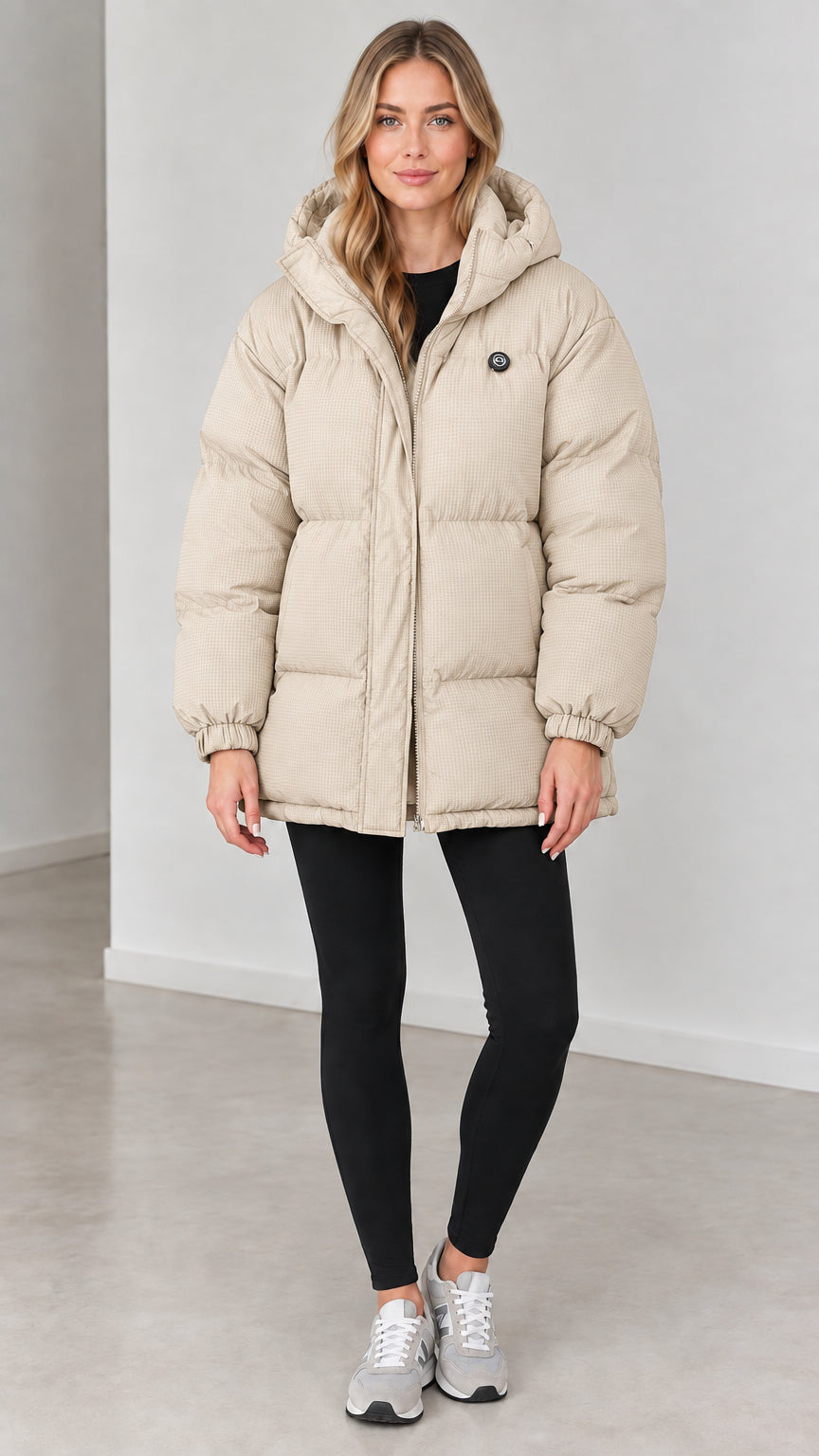 Front view of woman wearing cream beige hooded quilted puffer jacket