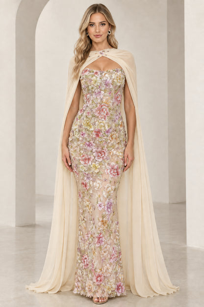 Model wearing champagne ivory floral embroidered formal dress with delicate sheer cape