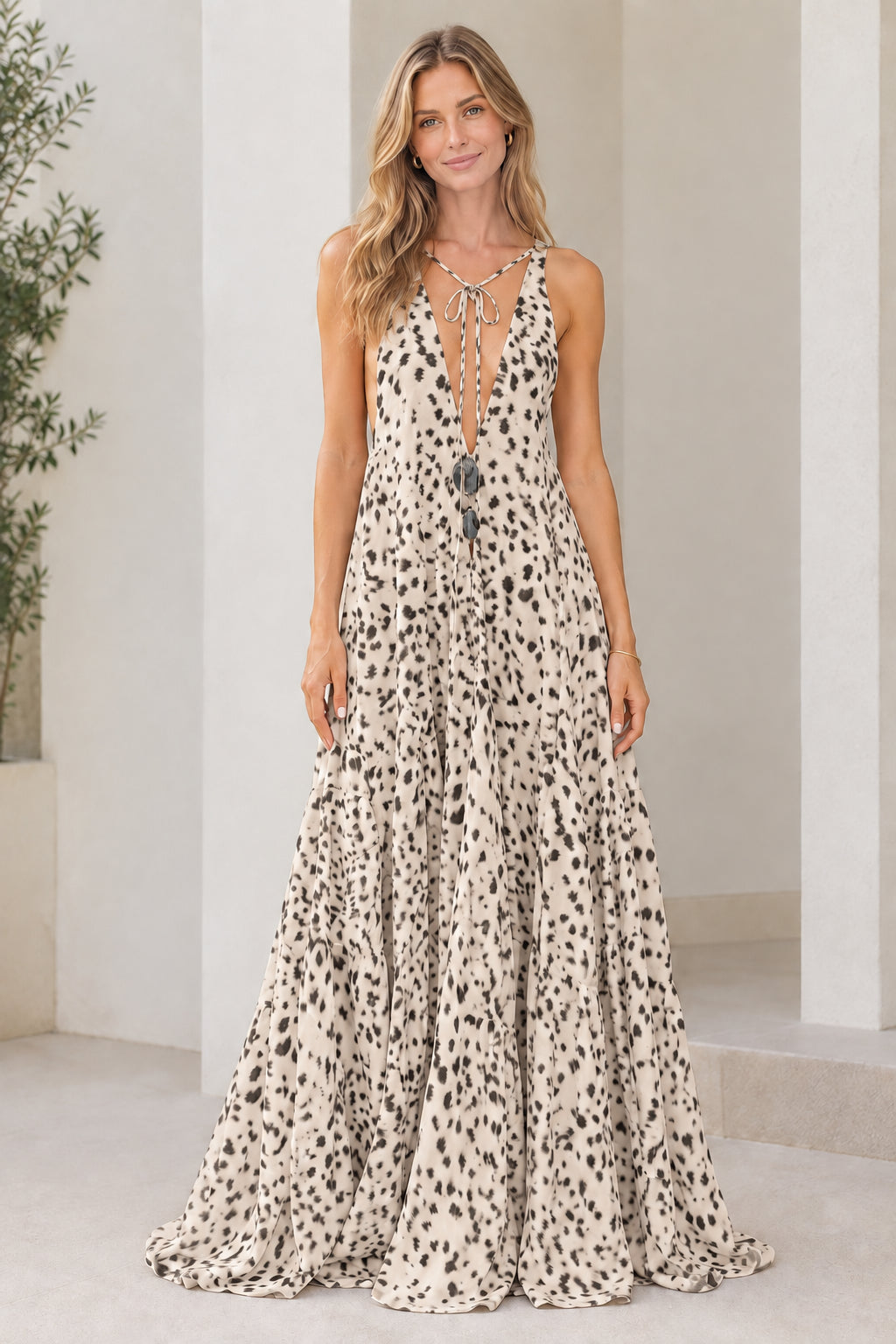 Model wearing beige tan dotted sleeveless plunge tiered maxi dress