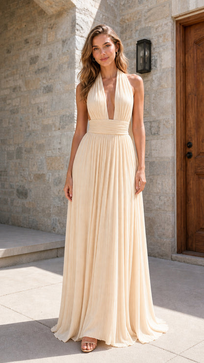 Model wearing champagne pleated halter maxi dress