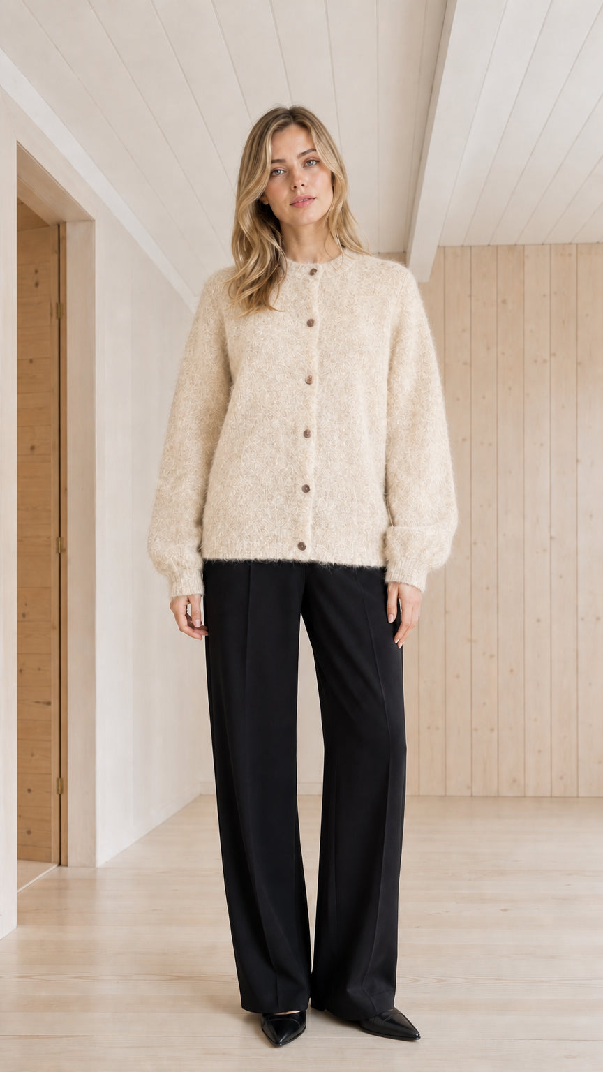 Model wearing cream fuzzy crewneck button-front cardigan sweater