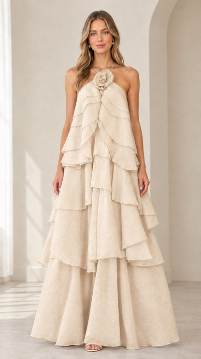 Full-length front view of model wearing Champagne beige tiered rosette maxi gown