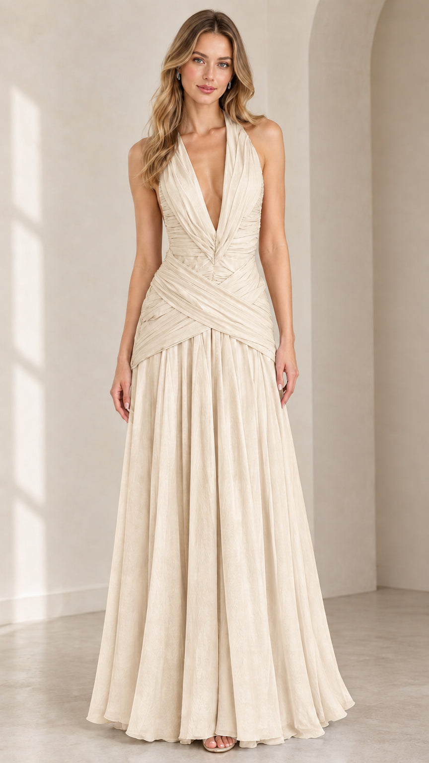Front view of champagne pleated plunge halter evening gown