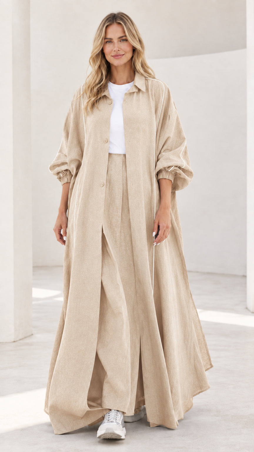 Woman wearing neutral beige sand maxi duster and wide leg trousers set
