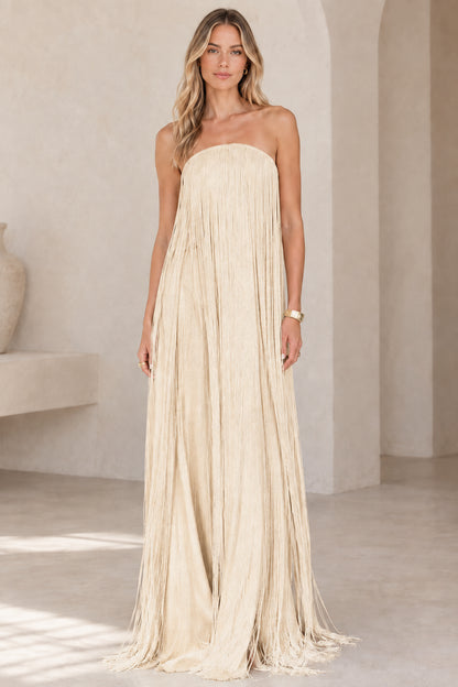 Full-length view of model wearing champagne beige strapless fringe maxi gown