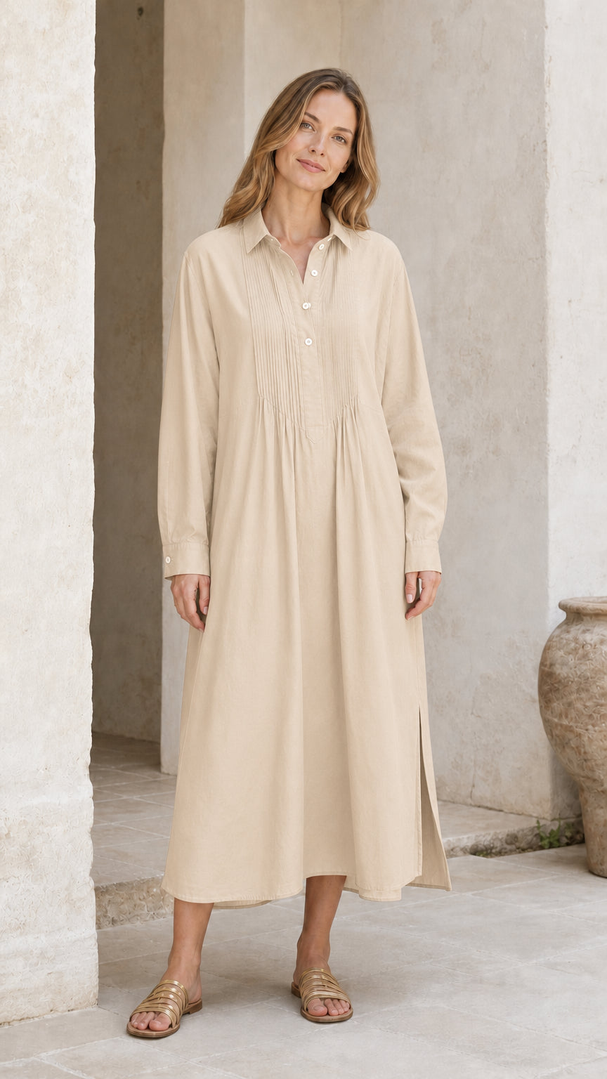 Woman wearing beige cream long sleeve pleated midi shirt dress