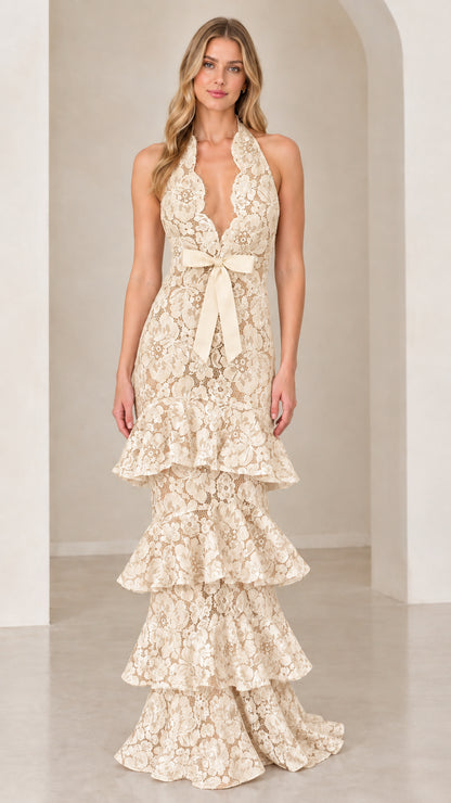 Front view of model wearing Champagne cream halter tiered floral lace evening gown